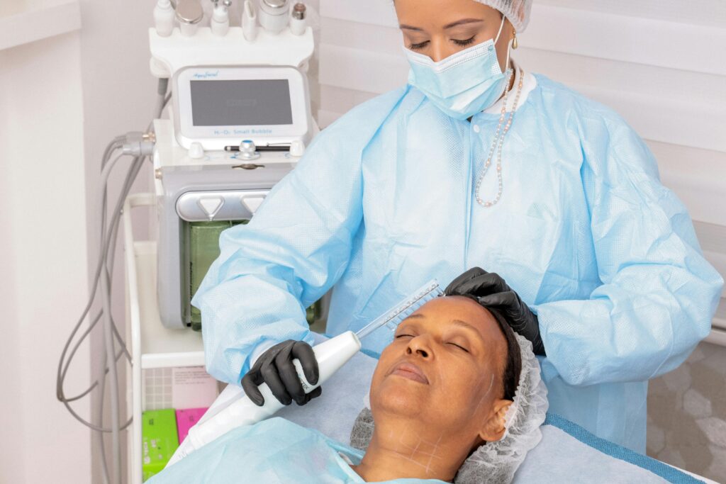 Woman receiving a professional facial treatment with advanced equipment in a spa environment.