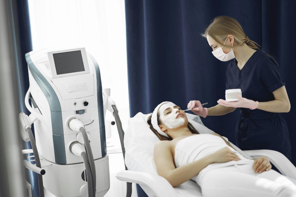 Woman receiving a rejuvenating facial treatment at a spa from a skilled therapist.