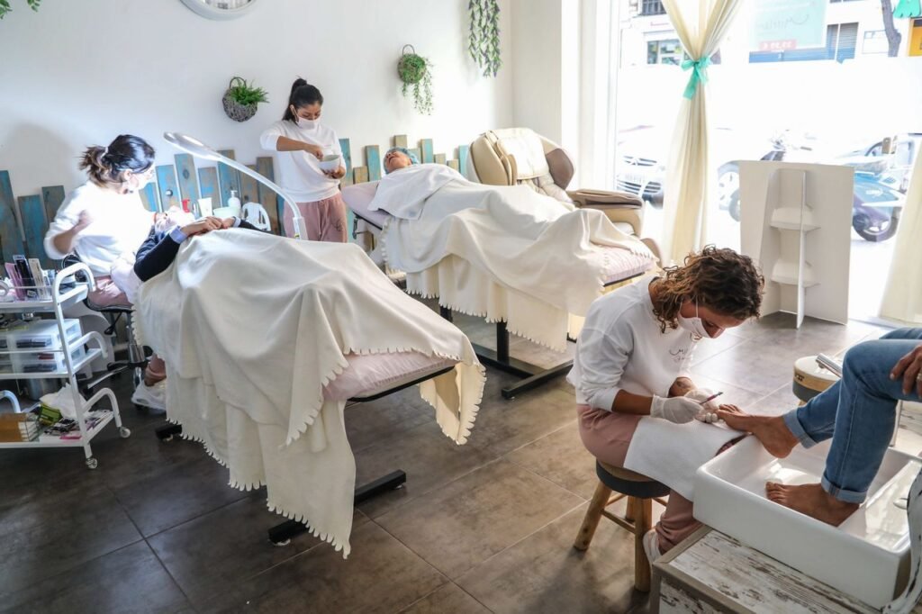 Peaceful spa scene with professionals giving facial and pedicure treatments in a well-lit salon. beauty salon marketing tipsskincare business trendslocal SEO for salonsbeauty services in London