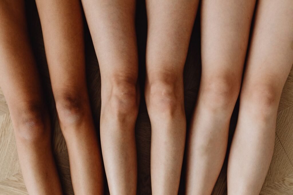 Close-up of diverse human legs highlighting body diversity. Top view arrangement.