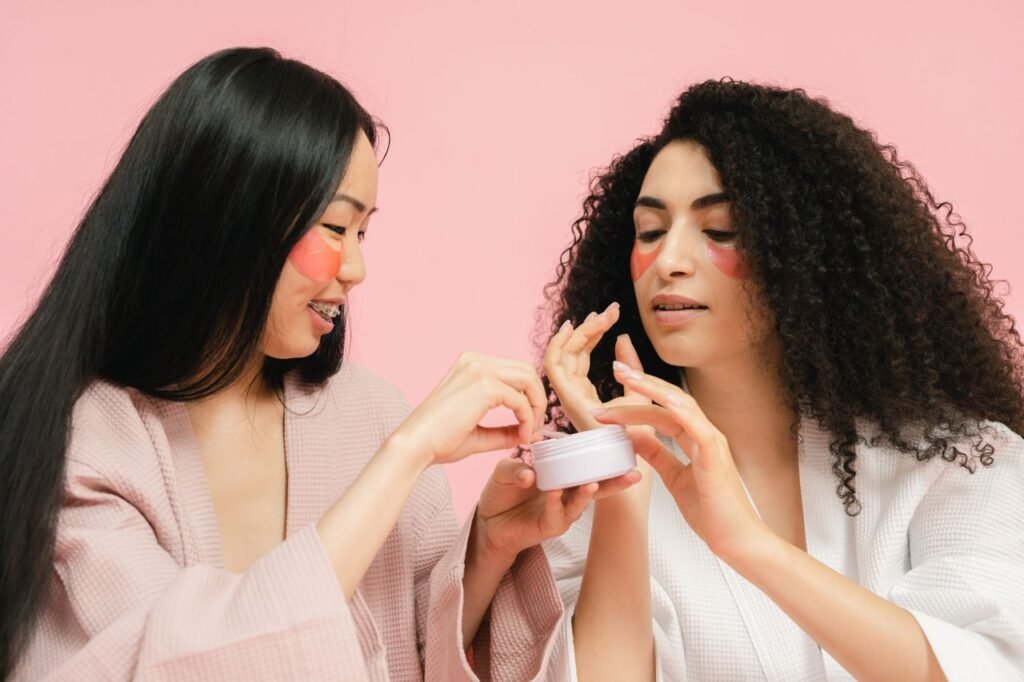 Two women with facial patches apply skincare cream, enhancing beauty and self-care routine. - beauty salons london - best of top ranking 2026
