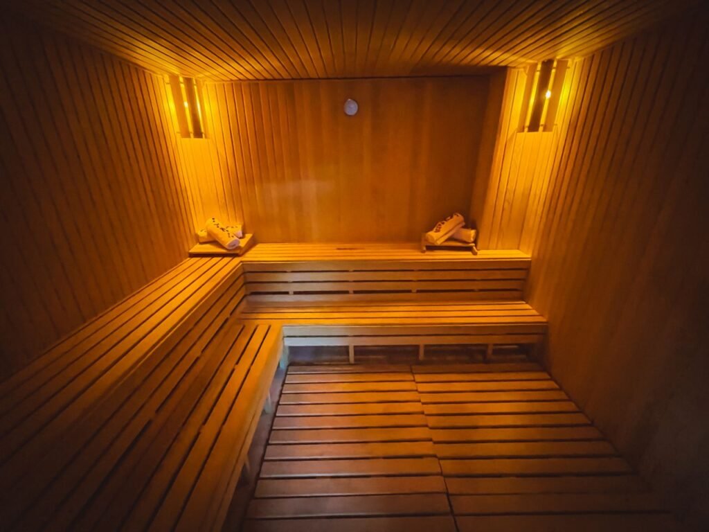 A cozy wooden sauna interior with warm lighting creating a relaxing atmosphere.